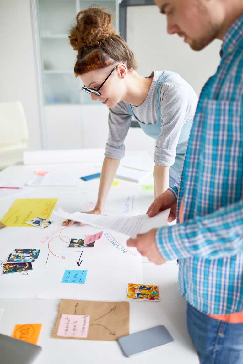 2 people looking over design